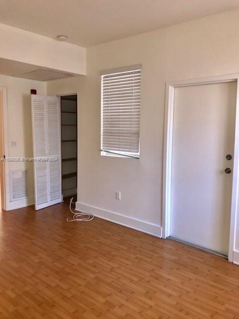 unfurnished bedroom with wood-type flooring