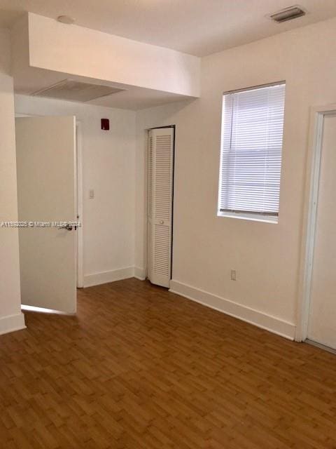 spare room with dark hardwood / wood-style flooring