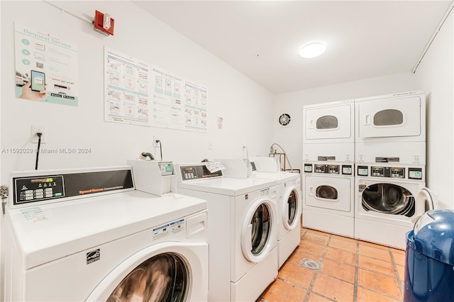 washroom with washer and dryer, stacked washer / drying machine, and light tile floors