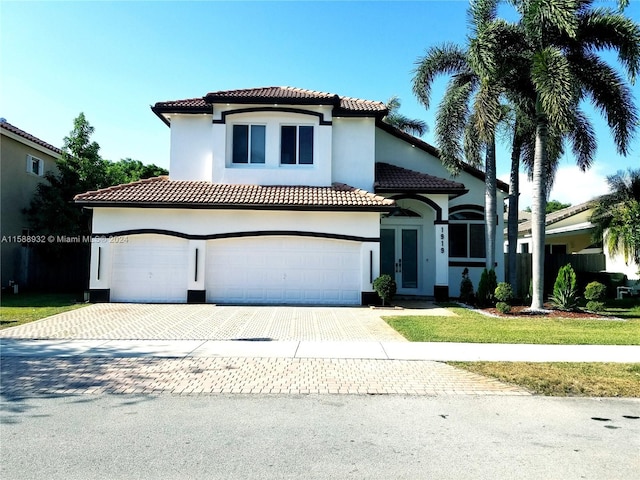 mediterranean / spanish-style house with a garage