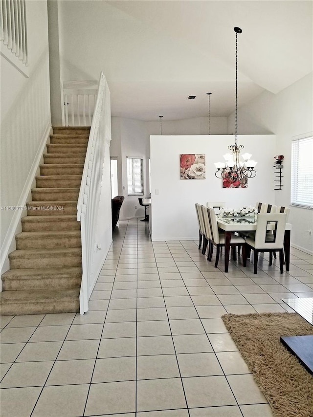 dining room featuring light tile patterned flooring, a chandelier, and high vaulted ceiling