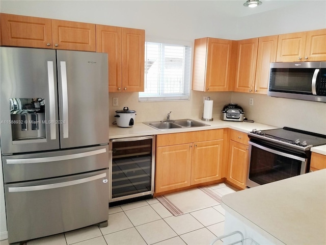 kitchen featuring sink, appliances with stainless steel finishes, wine cooler, and light tile patterned floors