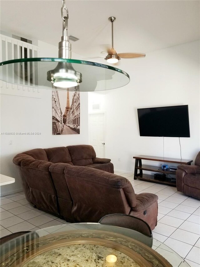 living room featuring light tile patterned floors and ceiling fan