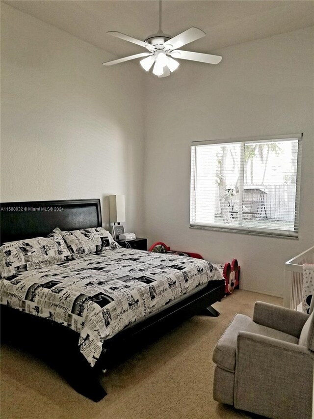 bedroom featuring high vaulted ceiling, multiple windows, ceiling fan, and carpet flooring