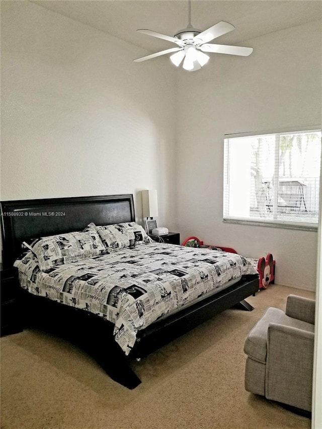 carpeted bedroom featuring lofted ceiling and ceiling fan