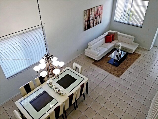 tiled living room featuring a notable chandelier