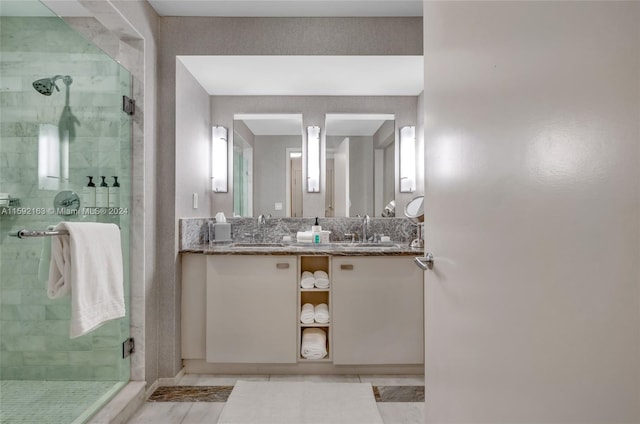 bathroom featuring tile flooring, an enclosed shower, and vanity