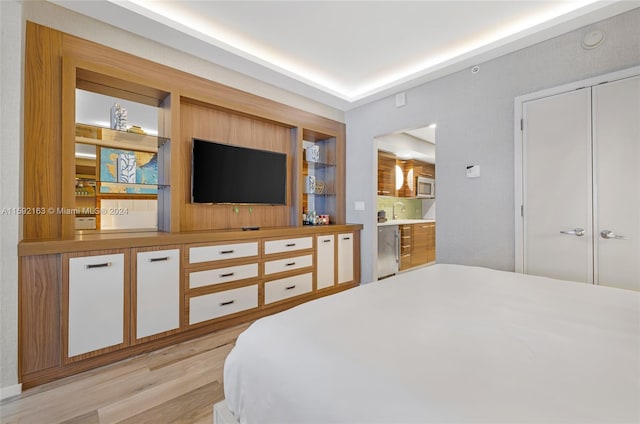 bedroom with a closet and light hardwood / wood-style flooring