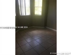 spare room featuring tile floors