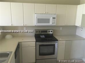 kitchen featuring white cabinets, sink, and stainless steel electric range oven