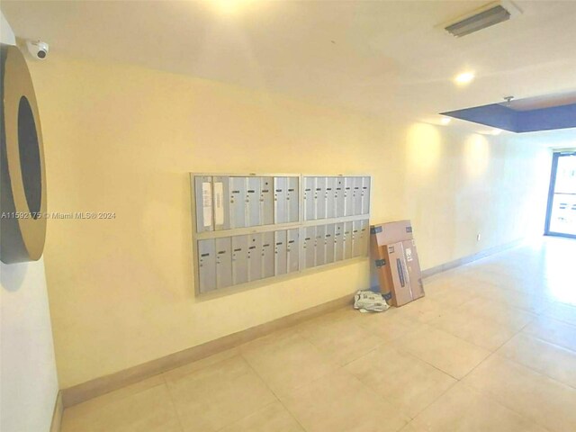 tiled spare room with mail boxes