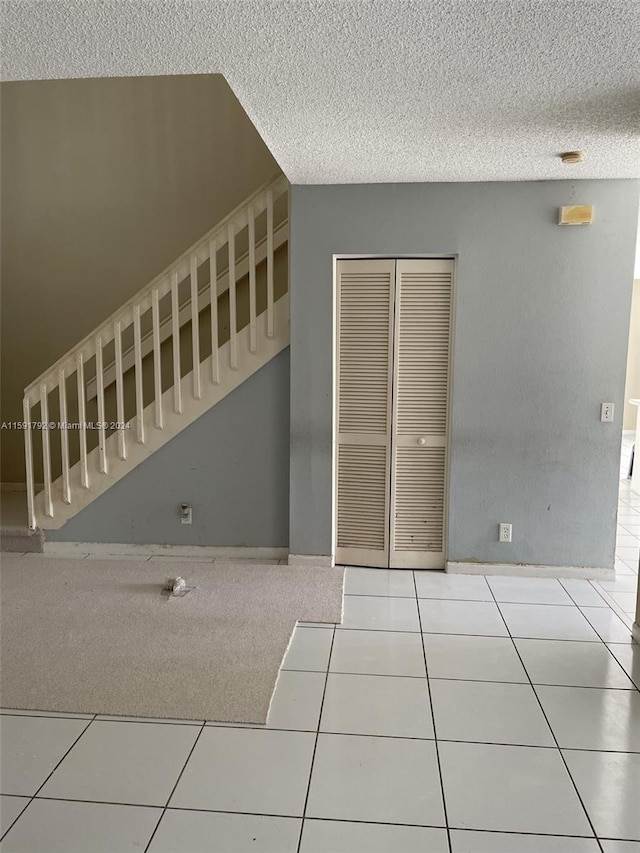 staircase featuring light tile floors