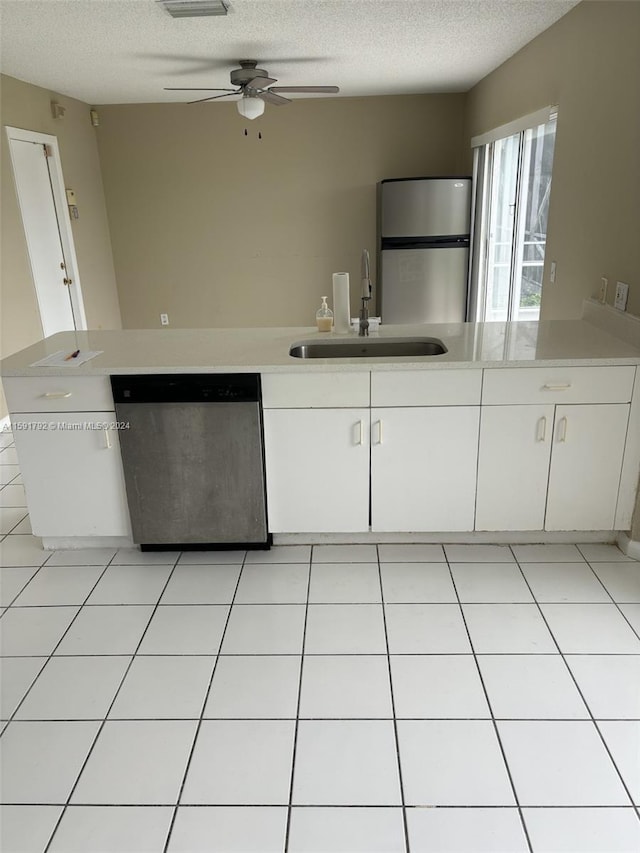 kitchen featuring appliances with stainless steel finishes, white cabinets, sink, light tile flooring, and ceiling fan