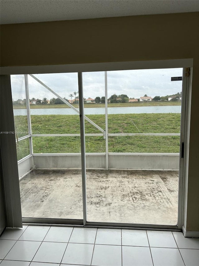 unfurnished sunroom with a healthy amount of sunlight and a water view