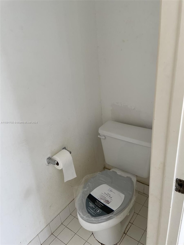 bathroom with tile flooring and toilet