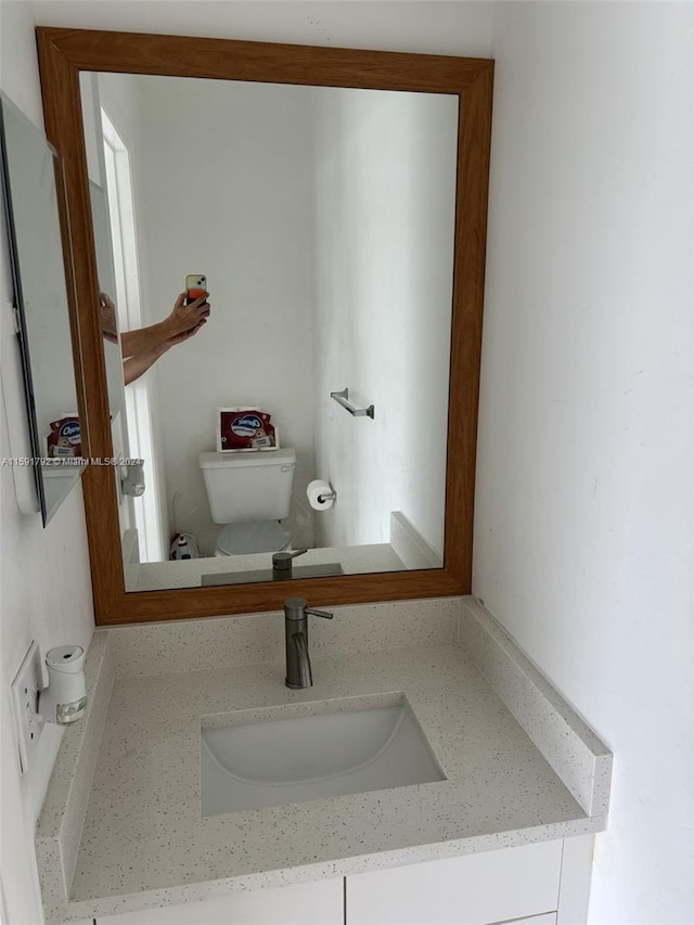 bathroom featuring large vanity and toilet