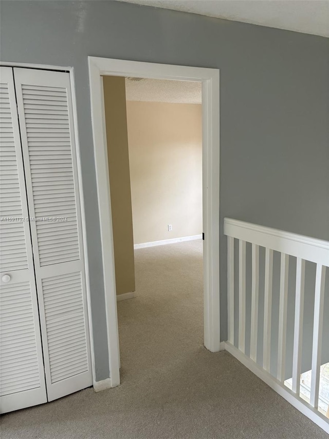 hallway featuring carpet flooring