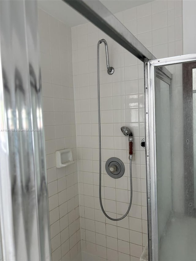 bathroom featuring a shower with shower door