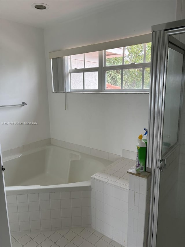 bathroom with a relaxing tiled bath