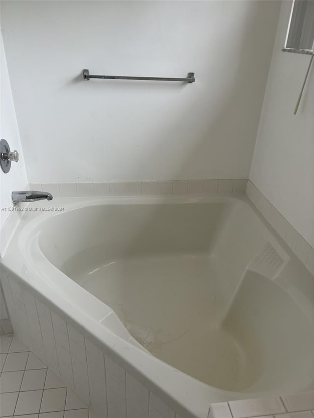 bathroom with tile floors and a relaxing tiled bath