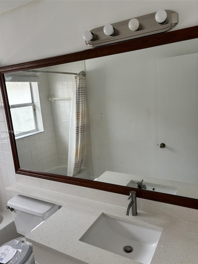 full bathroom featuring vanity, toilet, and shower / tub combo with curtain