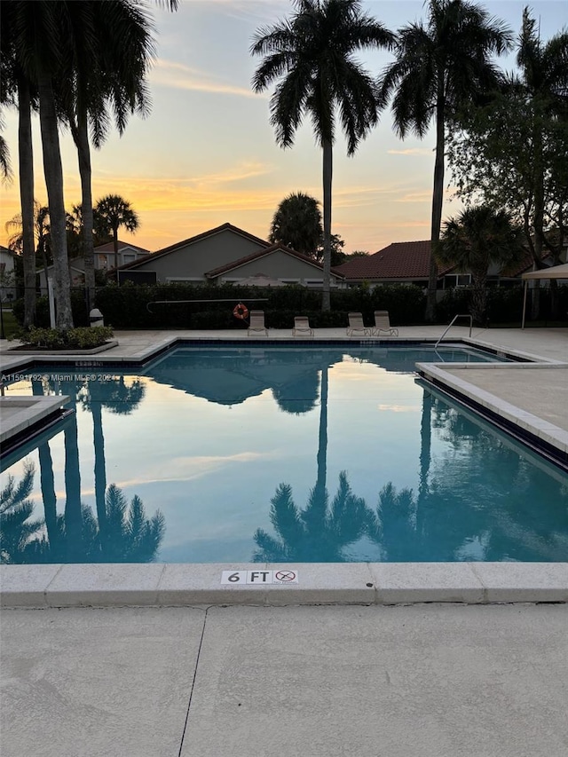 view of pool at dusk