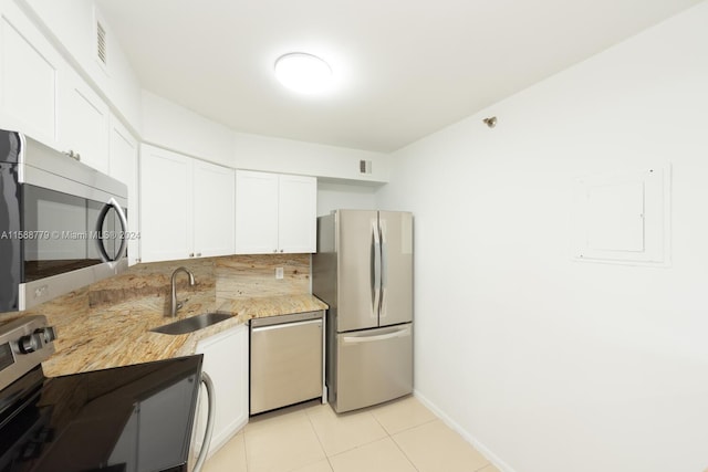 kitchen featuring white cabinetry, appliances with stainless steel finishes, sink, and light tile floors