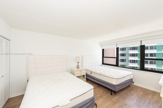 bedroom with a closet and hardwood / wood-style flooring