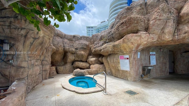 view of pool with a community hot tub and a patio