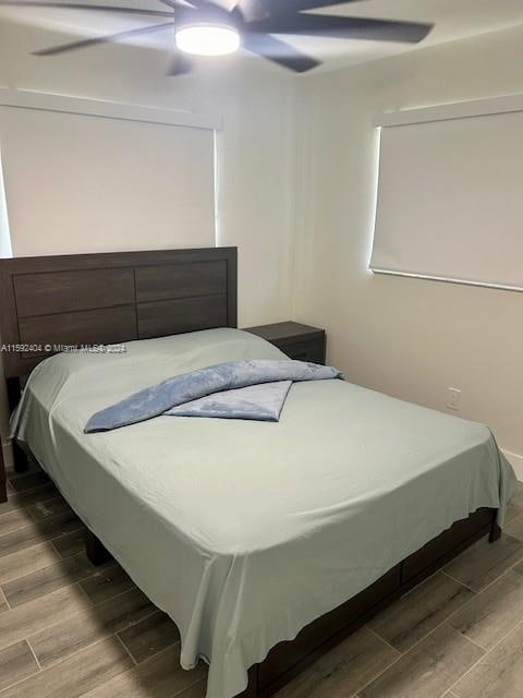 bedroom featuring hardwood / wood-style floors and ceiling fan