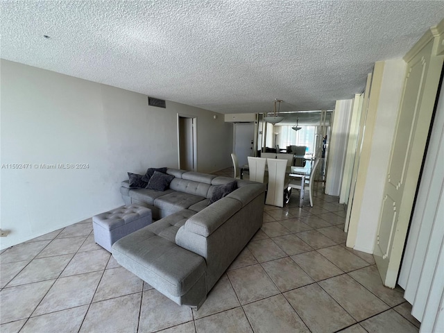 tiled living room featuring a textured ceiling