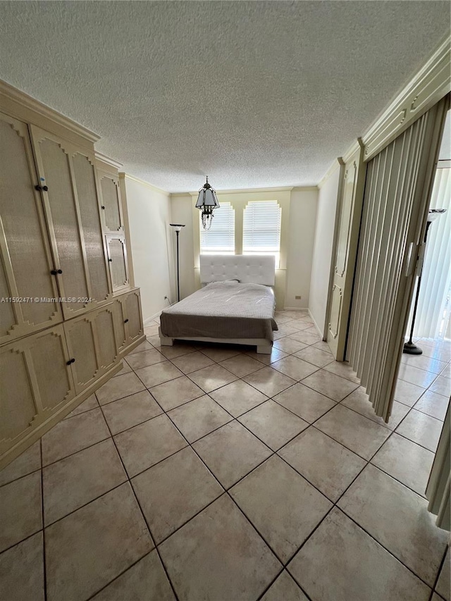 unfurnished bedroom with a textured ceiling and light tile floors