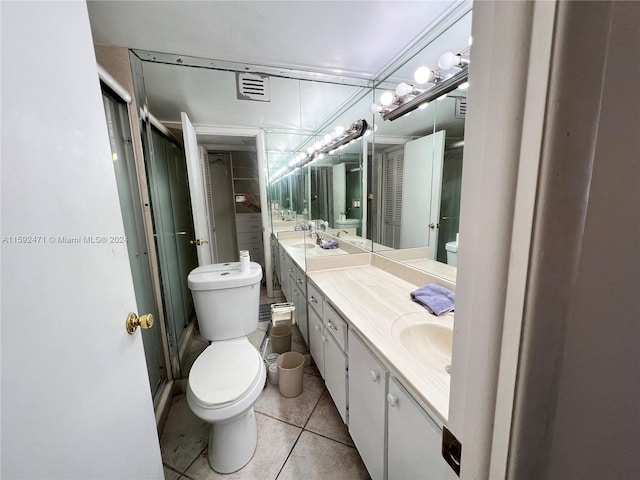 bathroom featuring tile floors, toilet, and vanity