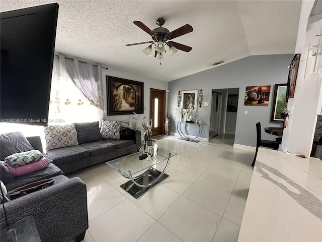 tiled living room with ceiling fan, a textured ceiling, and lofted ceiling