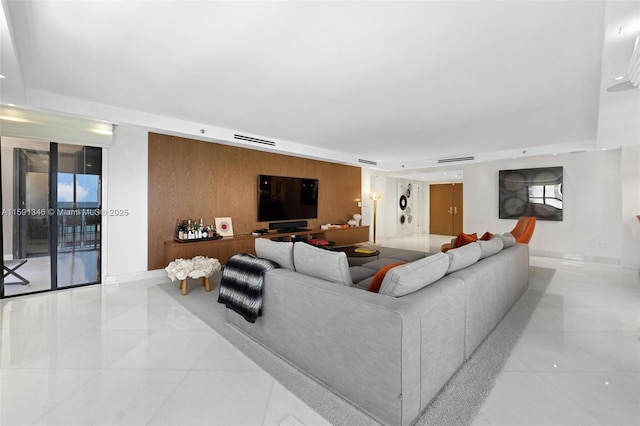 living room featuring visible vents and wooden walls