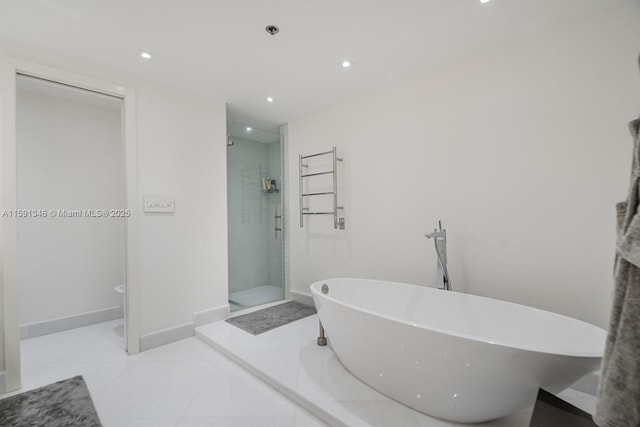 full bath featuring a freestanding tub, recessed lighting, baseboards, tile patterned floors, and a stall shower