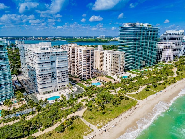 aerial view with a view of the beach, a water view, and a view of city