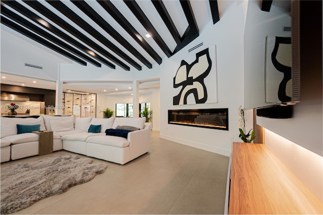 living room with beamed ceiling and high vaulted ceiling