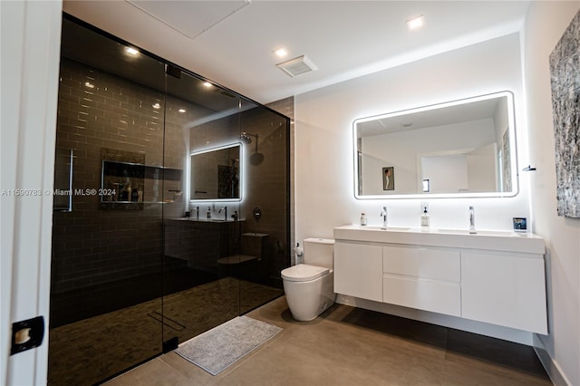 bathroom featuring tile floors, a shower with shower door, toilet, and large vanity