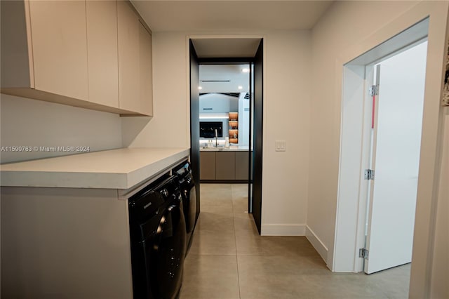 kitchen featuring sink and light tile flooring