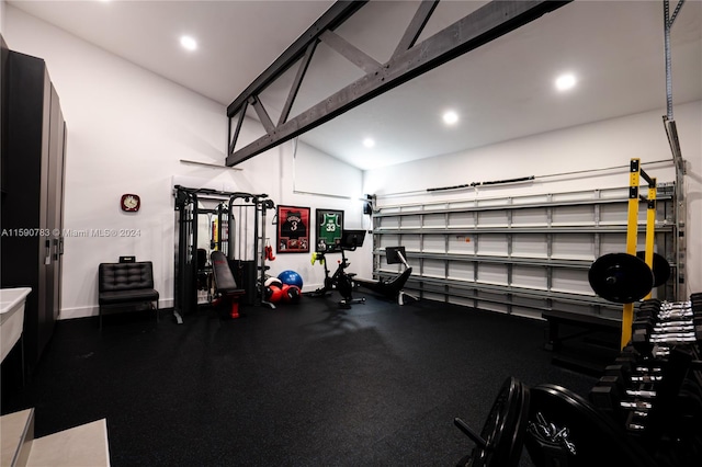 gym featuring vaulted ceiling