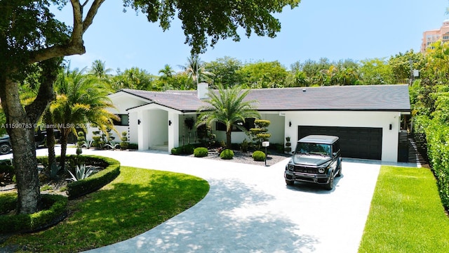 ranch-style home with a front yard and a garage