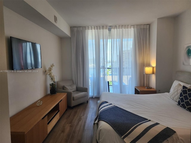 bedroom with dark wood-type flooring