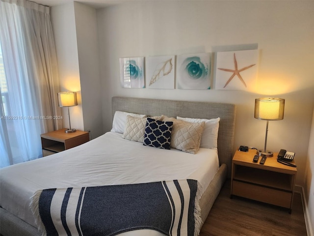 bedroom with dark wood-type flooring