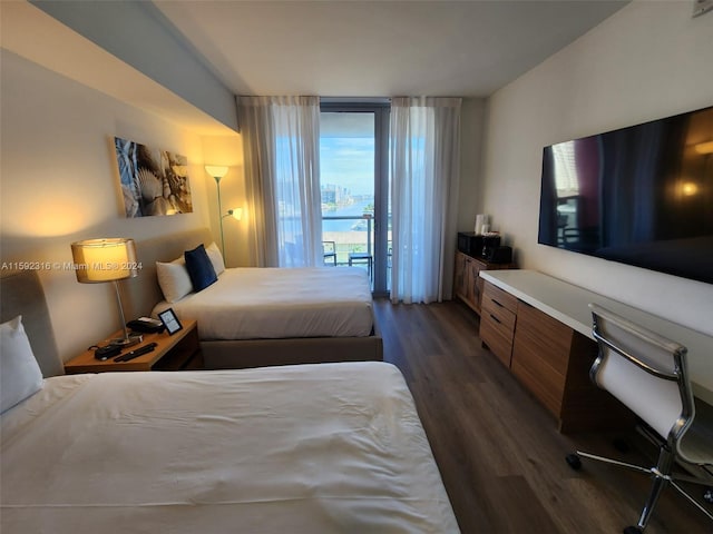 bedroom featuring dark wood-type flooring and access to exterior