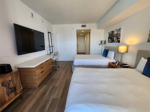 bedroom with dark hardwood / wood-style flooring