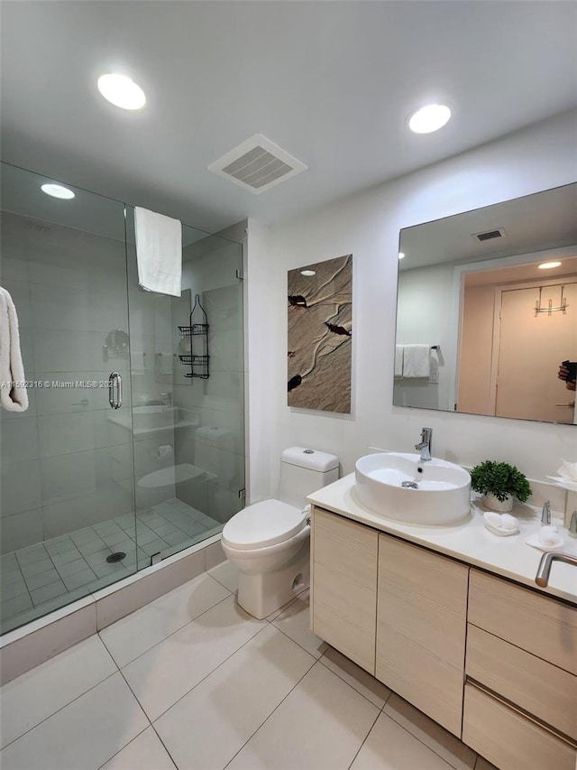 bathroom featuring toilet, tile patterned flooring, walk in shower, and vanity