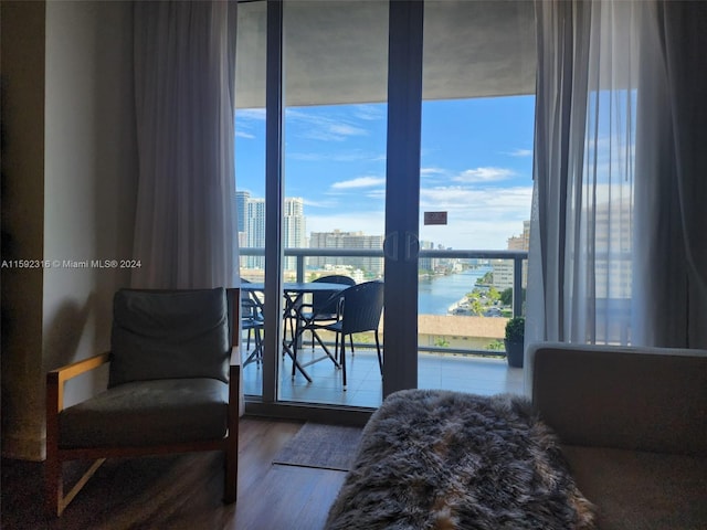 bedroom featuring hardwood / wood-style flooring and a water view