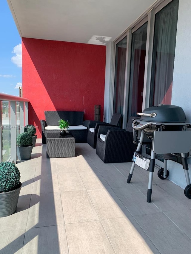 view of patio / terrace with an outdoor living space, a balcony, and grilling area