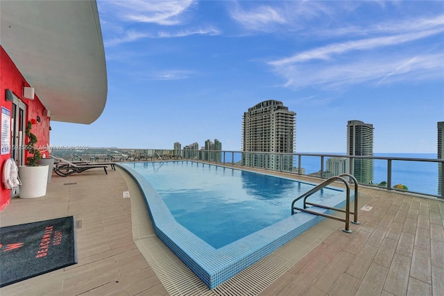 view of swimming pool featuring a water view